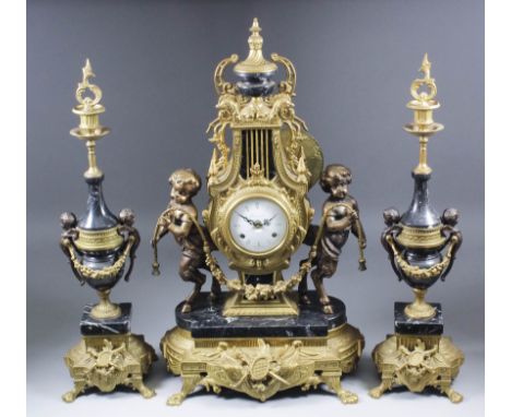 A modern Italian gilt metal and black marble cased three piece clock garniture, the clock with 3.5ins diameter white enamel d