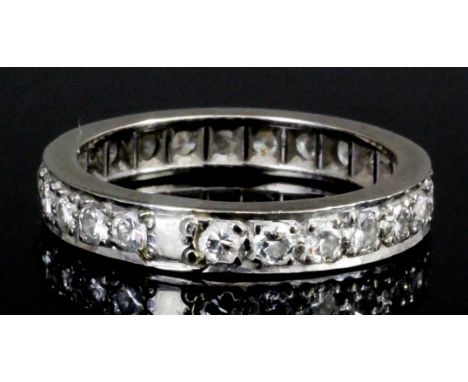 A modern silvery coloured metal mounted all diamond set eternity ring, the face set with twenty-four brilliant cut diamonds, 