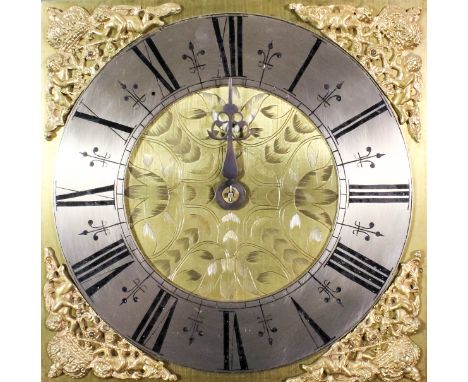 An 18th Century oak long case clock, the 11ins square brass dial with silver chapter ring with Roman numerals, the dial centr