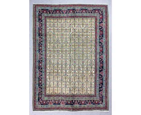 A Persian Kolyai carpet woven in colours with a central trellis pattern, in-filled in dark green with small boteh ornaments, 