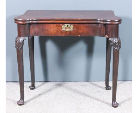 A mid-18th Century Cuban mahogany card table of shaped outline with double folding top, the upper tier opening to reveal baiz