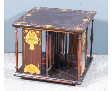 A late Victorian mahogany square table top revolving bookcase inlaid in the "Art Nouveau" manner, with stylised floral orname