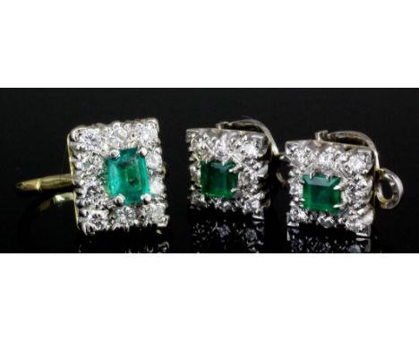 A modern 18ct white and yellow gold mounted emerald and diamond ring, the rectangular cut emerald of approximately 1ct, borde