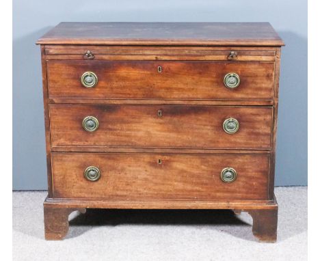 A George III mahogany chest with moulded edge to top, fitted with a brushing slide and three long drawers with original brass
