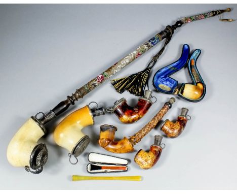 A silver plated mounted plain meerschaum pipe with turned wood and glass bead stem, 29ins, and a collection of similar pipe b