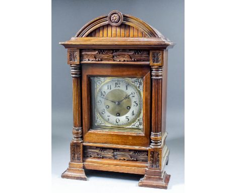 A late 19th Century German walnut cased mantel clock, the brass dial with 5.5ins diameter silvered chapter ring with Arabic n