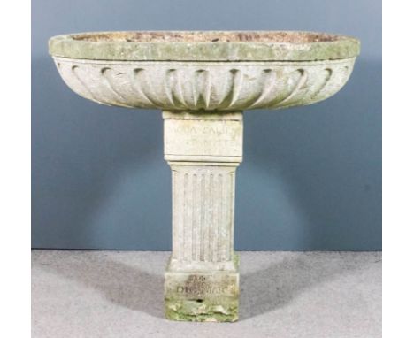 A limestone oval trough with fluted sides, 47ins wide x 24ins deep x 12ins high (edge repaired), mounted on rectangular pedes