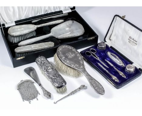 An Elizabeth II silver backed four piece dressing table set of "Art Deco" design, the backs with rectangular vacant cartouche