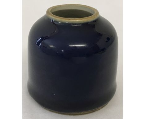 A small Chinese brush wash pot with deep blue glaze and ring mark to underside.  Approx. 6cm tall x 6.5cm diameter.