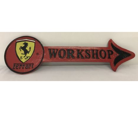 A painted cast iron wall hanging Ferrari Workshop arrow. In red, black and yellow, with screw fixing holes. Approx. 12cm x 42