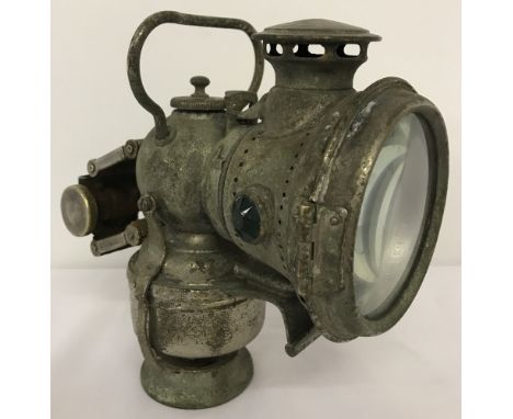 A Lucas "King of the Road" acetylene carbide bicycle lamp with red &amp; green side jewels.  Approx. 19cm tall.