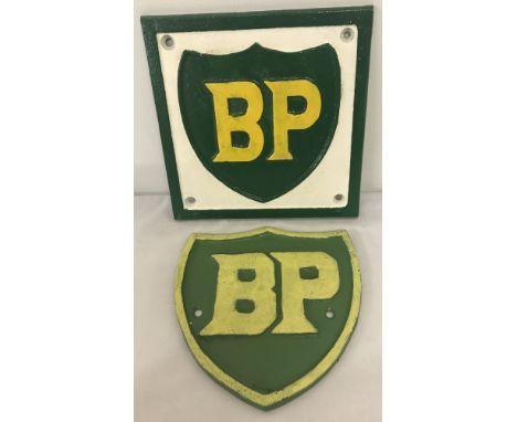 2 cast iron BP wall plaques, painted green, white and yellow. One square shaped, the other shaped like a shield. Largest appr