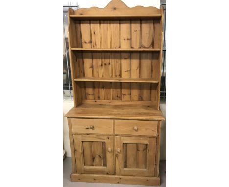 A vintage pine double dresser, in 2 sections. 3 open shelves to top and 2 drawer, 2 door cupboard to base with interior shelf