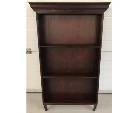 A modern mahogany coloured wall hanging shelf with carved detail to top. 3 shelves with plate grooves. Approx. 113cm tall x 6