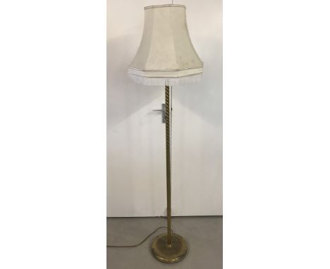 A vintage brass standard lamp together with a cream octagonal lampshade.  