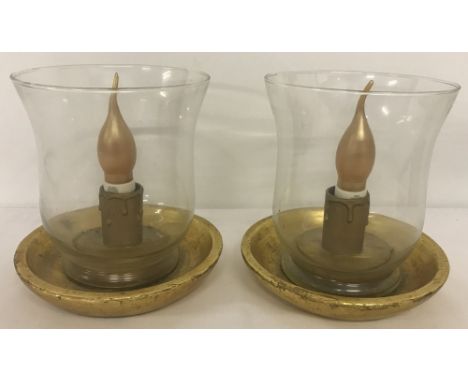 A pair of vintage table lamps; clear glass shades sat on wooden bases, painted gold.  Approx. 18.5cm tall.