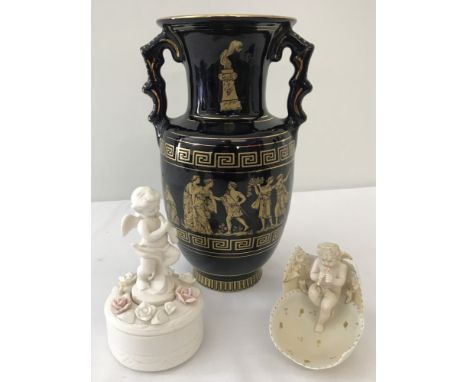 A small continental bisque ceramic cherub sitting in an egg, with hand painted gilt detail. Together with a more modern bisqu