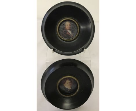 A pair of circular shaped, wooden framed, portrait miniatures. With brass rim. Approx. 9.5cm diameter.
