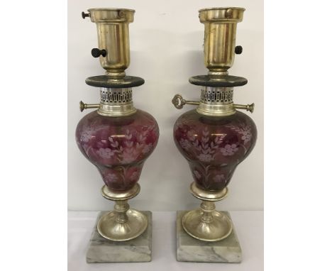 A pair of vintage lamps with etched cranberry coloured glass bowls, mounted onto marble plinths.  Both approx. 41cm tall.