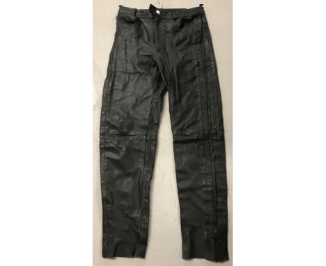 A pair of vintage black leather trousers with eyelet detail to both legs,  Size 32.