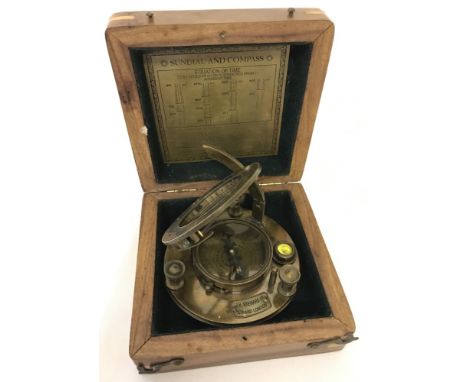 A wooden cased brass sundial and compass, marked J.H.Steward Ltd, Strand, London.  Box approx. 5.5cm tall x 13.25cm².