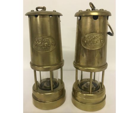 2 vintage brass Welsh miners lamps with "Cymru" plaques to front.  Standing height approx. 22.5cm tall.