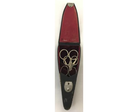 A collection of 3 vintage pairs of scissors. Contained in a leather case with red silk lining.  To include stork shaped sewin