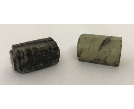 2 Chinese jade beads. An octagonal shaped bead with engraved Chinese symbols to each side, together with a square shaped bead