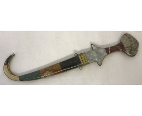 A vintage Eastern dagger with natural stone set handle and curve ended sheath.  Approx. 31cm long.