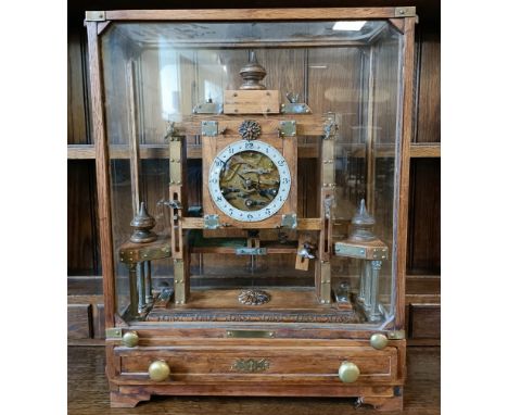 An unusual mantel clock, the silvered dial fitted an eight day triple train movement, striking on a chime, in a glazed case w