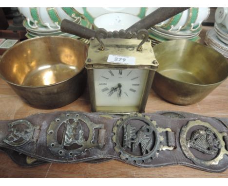 A vintage carriage clock , 2 brass saucepans and horse brasses