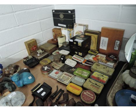 A selection of vintage cigar cigarette and tobacco smokers advertising tins, humidors and containers