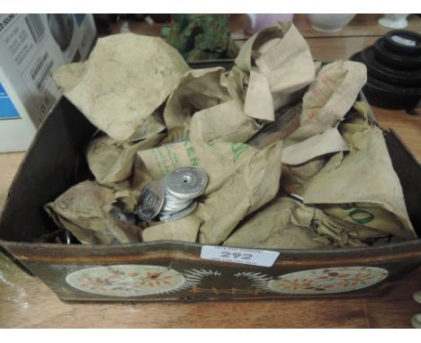 A vintage tin of transport tokens