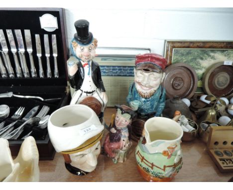 A selection of charter jugs and  decanters including Onnaing Majolica 'Drunken Army Reservist' pitcher AF and Melba ware punc