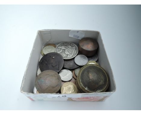 A selection of vintage collectable coins and currency including small penny containers 