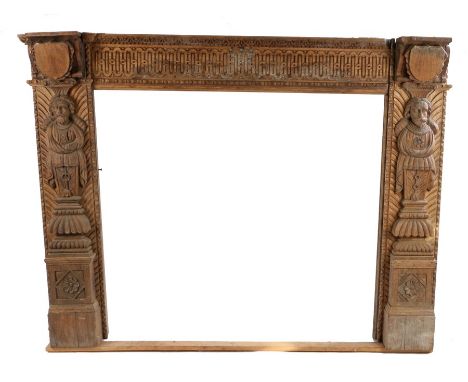 Mid to late 19th Century oak Elizabethan style fireplace, English, circa 1850 – 1880. The fire surround with twin Atlanta fig