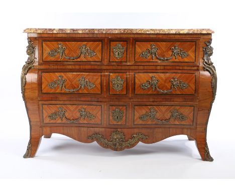 19th Century French tulipwood commode, the serpentine marble top above the bombe base with three long drawers and a deep apro