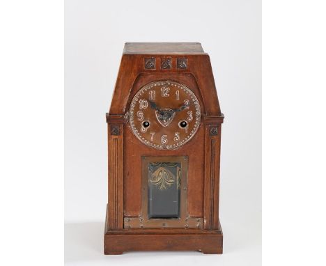 Arts and Crafts mantle clock, the dark stained case with tapering top section above reeded pilasters and bevelled glass pendu