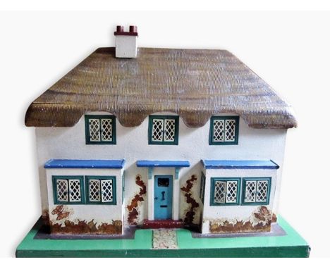 "Princess Elizabeth and Margaret's doll house" - double front thatched cottage with leaded light windows containing a quantit