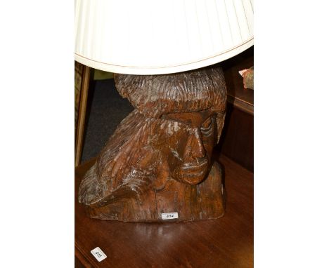 A large hardwood novelty lamp base, carved by Fichot, with a native American, head and shoulders, 44cm high