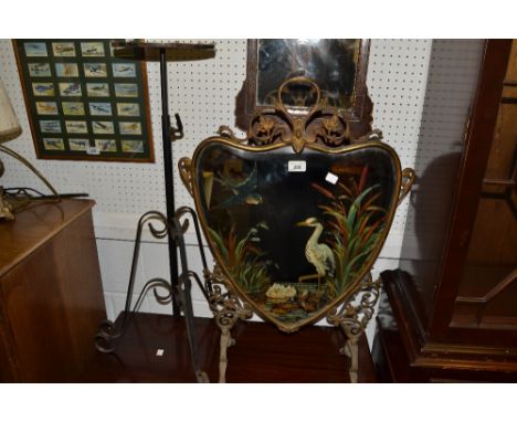 A late 19th century heart shaped mirrored  brass fire screen, painted with birds and rushes;  a cast iron stand (2)