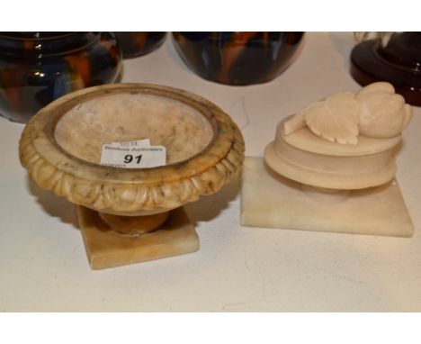 An alabaster pedestal urn; an alabaster pedestal jar and cover, the finial carved with a sprig (2)