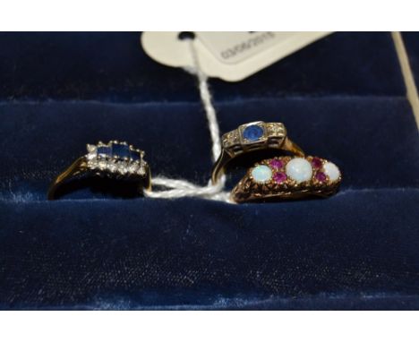 An opal and garnet seven stone ring, three cabochon opals inter - spaced with two pairs of pink garnets, 9ct gold shank;  ano