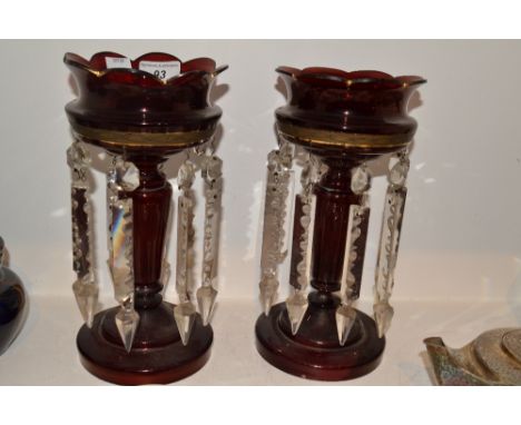 A pair of Victorian ruby glass lustres, spreading circular bases, 26cm high 