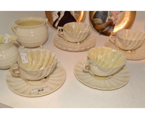 A Belleek Irish Porcelain Nautilus pattern set of four tea cups and six saucers, black printed marks, a Cauldron sugar bowl a