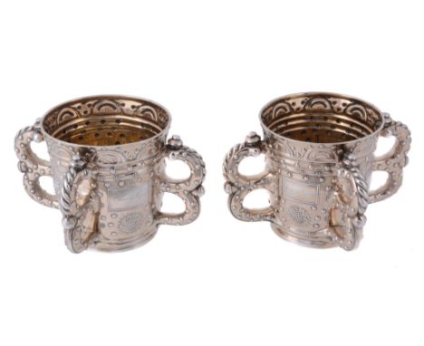 Two Edwardian silver gilt four-handled communal cups by R. & S. Garrard & Co  Two Edwardian silver gilt four-handled communal