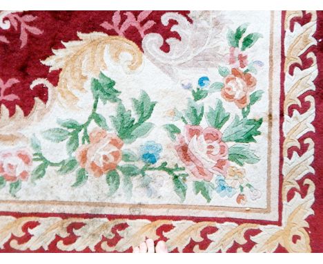 A large Chinese wool carpet with cream and red ground, floral decoration, 340cm x 245cm 
