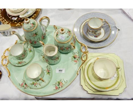 A porcelain early morning tea service of eight pieces viz:- teapot, sugar bowl, cream jug, two cups and saucers and circular 