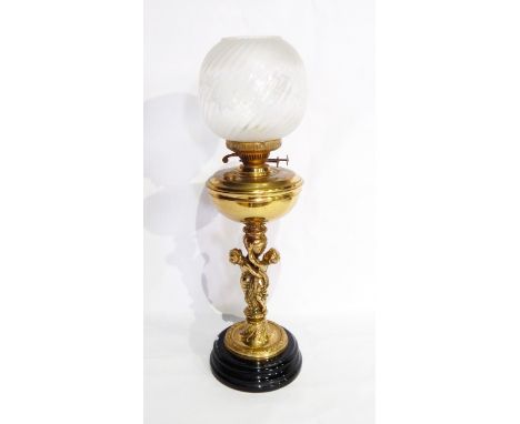 A brass oil lamp, the stem modelled as two embracing children and with globular glass shade, 68cm high 