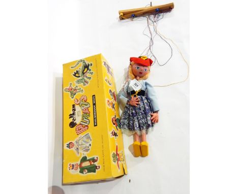 A Pelham puppet of a girl in a red felt cap, in box 